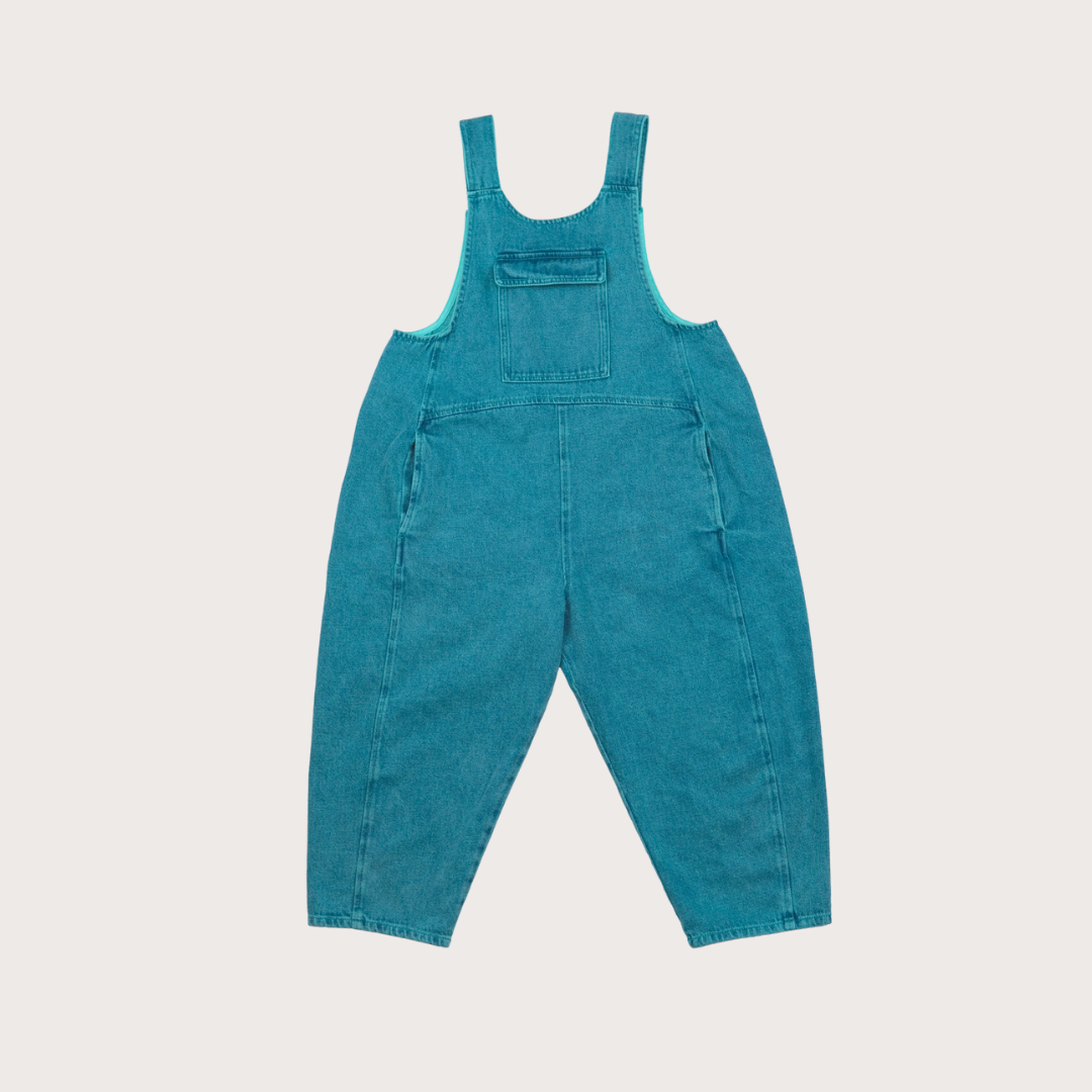 AW25 Kai oversized denim dungarees in turquoise overdye with curved seams and adjustable straps