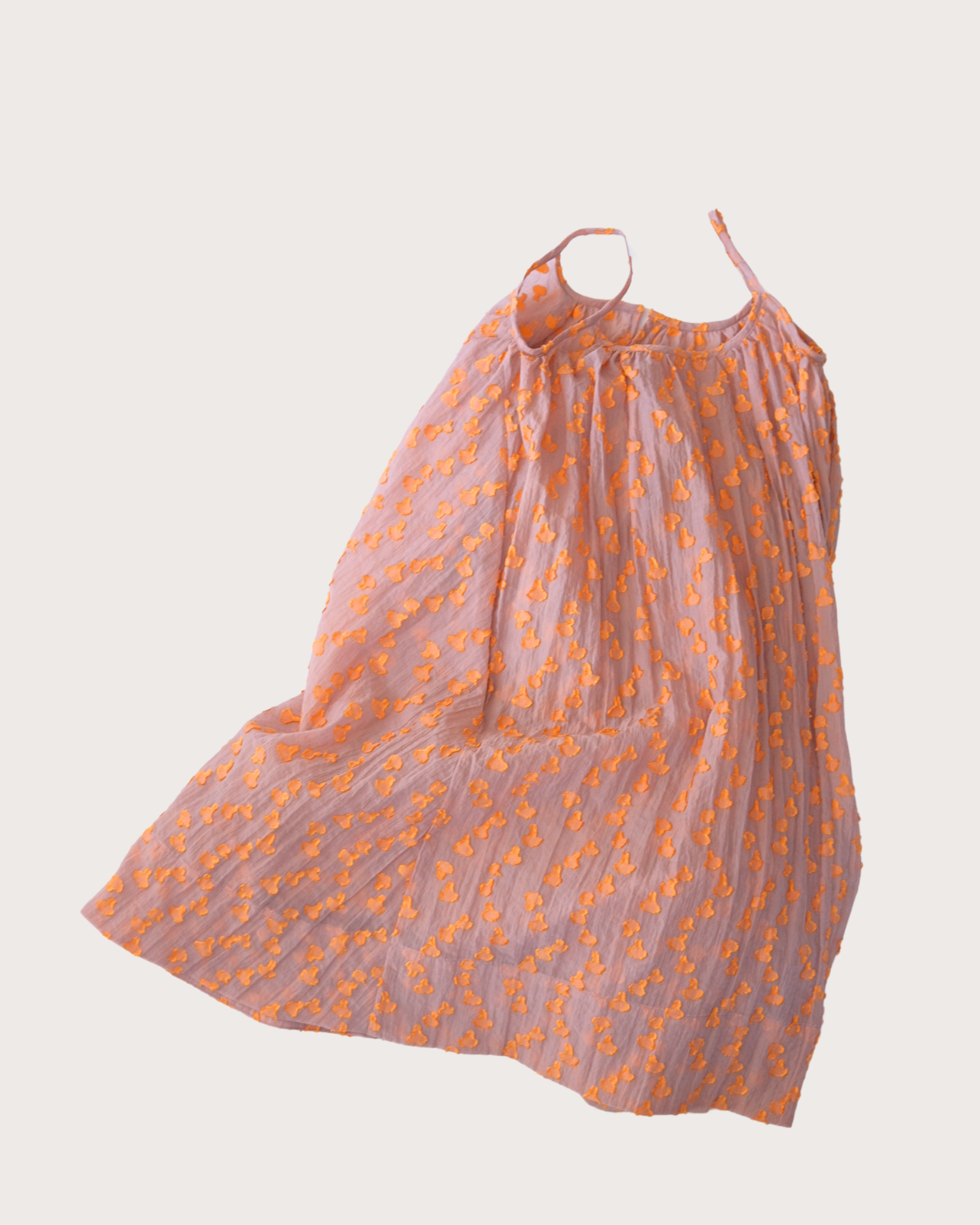 Close-up of sheer cotton fabric with raised dot texture on Cleo kids dress