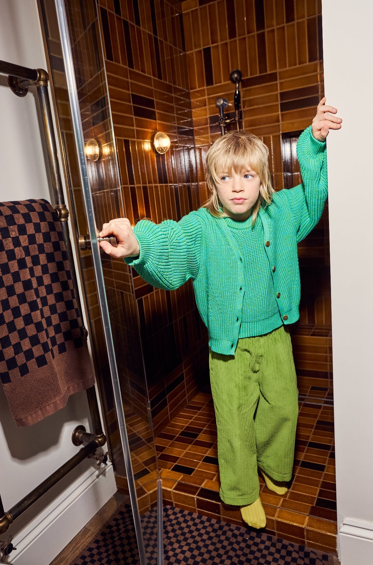 Child wearing green Studio Koter Ever corduroy trousers lifestyle shot showing comfortable fit
