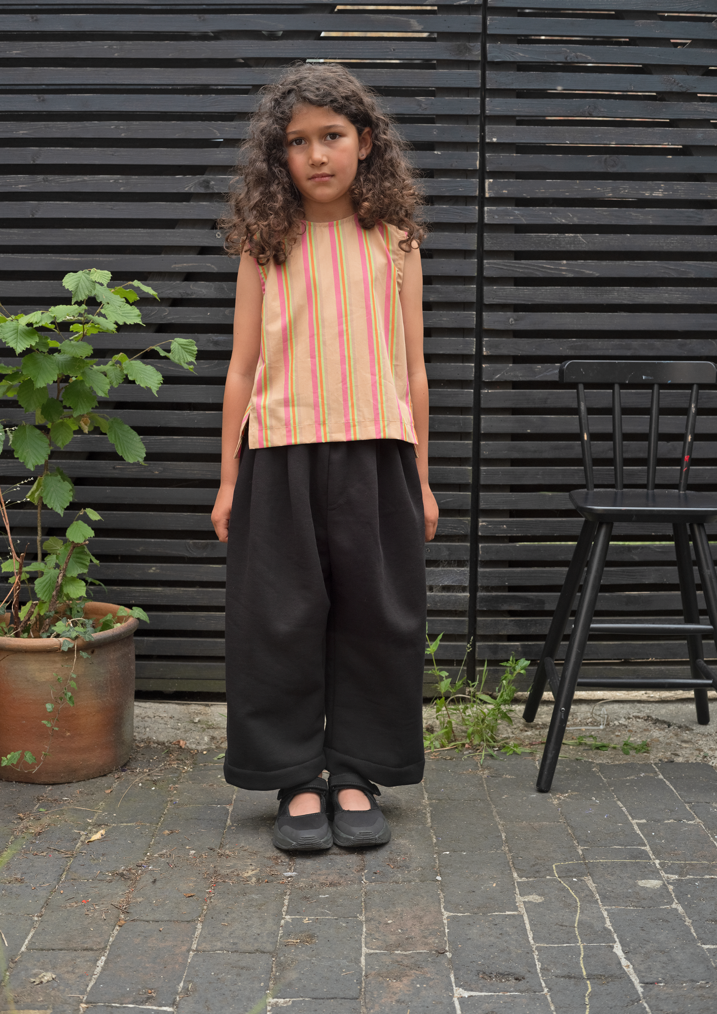 Modern black kids joggers with pleated front and relaxed silhouette