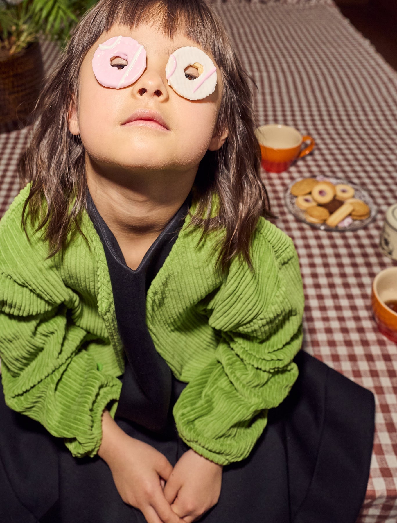 Child wearing Senna corduroy jacket playing with party ring biscuits - durable cotton kids outerwear